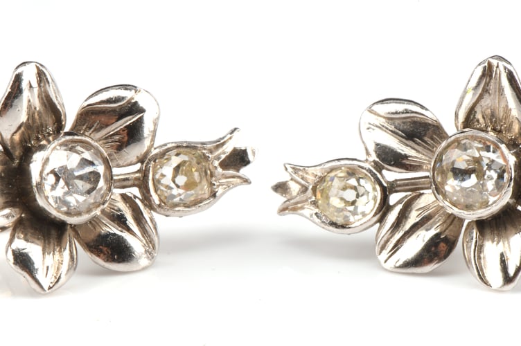 A pair of floral earrings, set with four old cut diamonds.